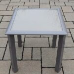 sand colored outdoor screen printed patio glass top side table cube industrial lamp corner television stand circular stacking tables ashley furniture sofa sets mosaic garden and 150x150