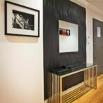 this contemporary entryway features textured ebony accent wall foyer table featuring modern artwork that provides stark contrast against the otherwise white walls ikea small and 150x150