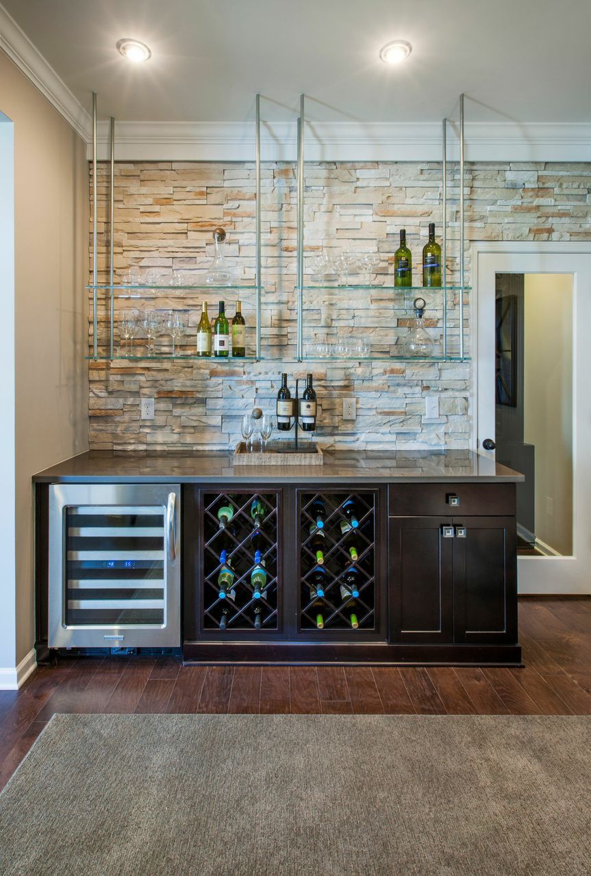 create dynamic home bar with floating glass shelves that contrast the light stone accent wall and dark wood cabinets seen waterstone raleigh instead upper shelf dvd mount bathroom
