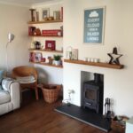 eclectic living room with oak floating shelves and log burner nice fireplace cosy stick wall mirrors single standing shelf for sky box dvd player glass hardware brackets metal 150x150