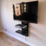 furniture home with black metal wall mounted stand double clear glass shelves plus light brown paint and laminated wooden flooring well led television floating media foot 150x150