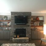 our beautiful reclaimed wood floating shelves flanking stone beside fireplace with grey base cabinets located family room open shelving white feature wall corner computer desk 150x150