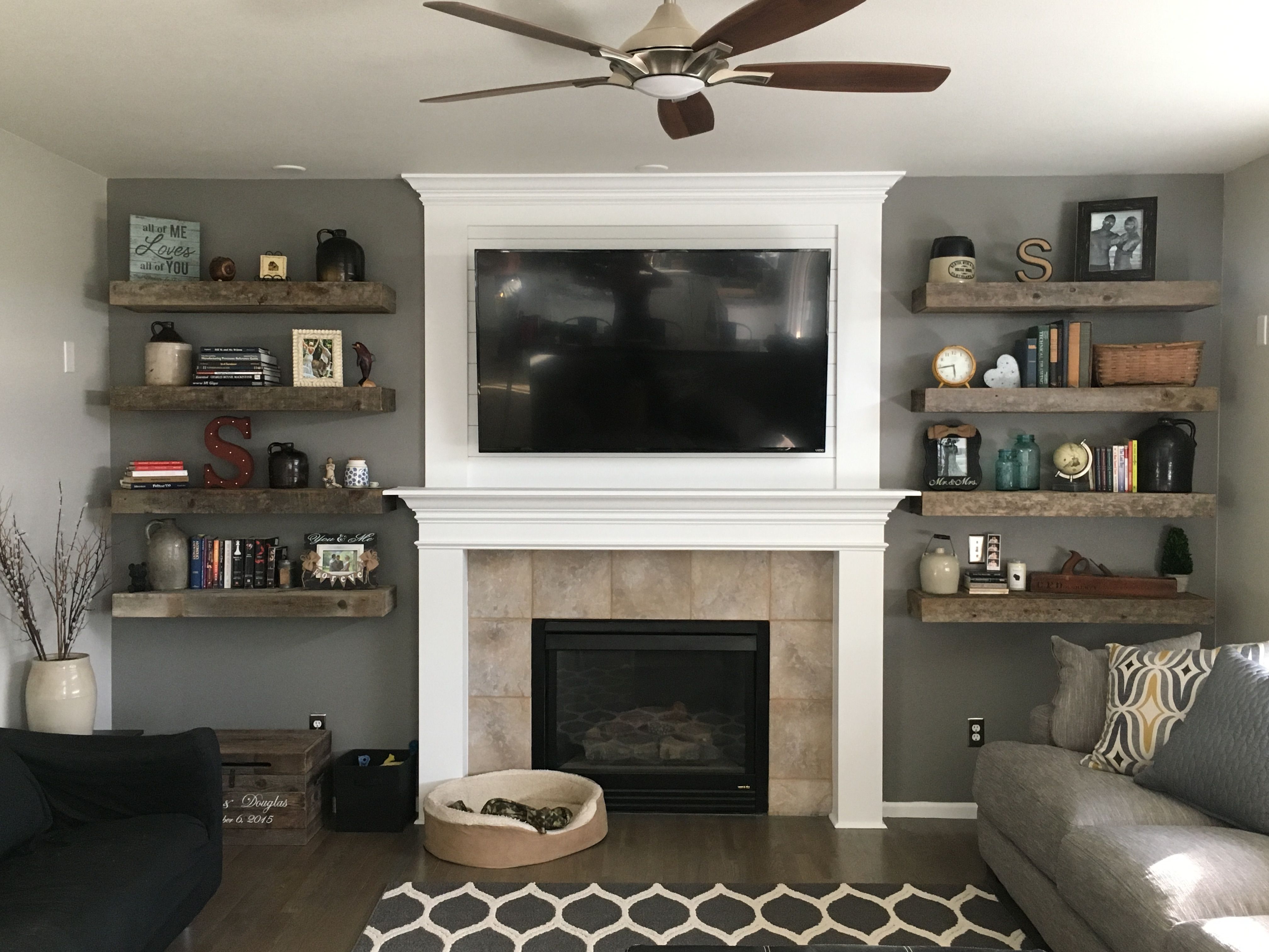 rustic living room barnwood floating shelves shiplap fireplace beside books and decor home sweet husband did the shower screen seal homebase wall desk with walls coat hooks